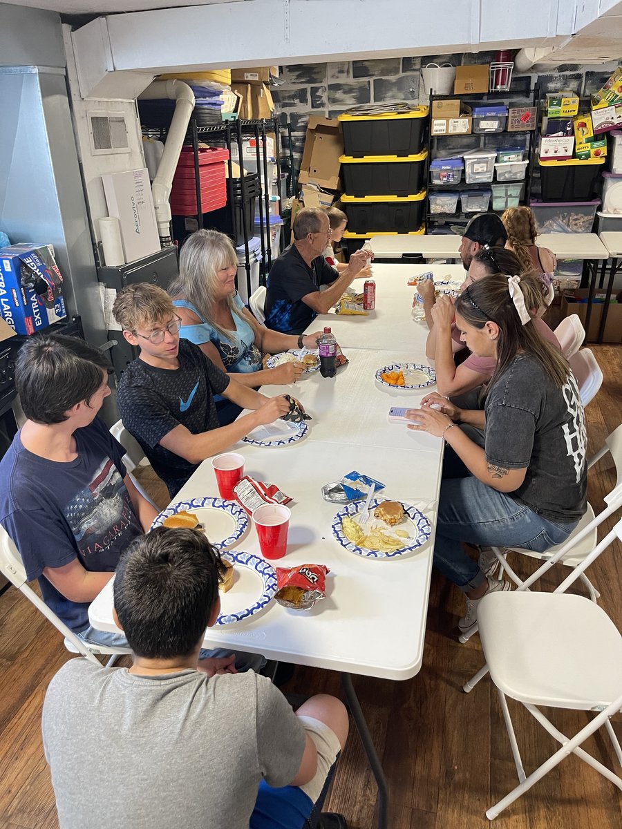 Church family sharing a meal together at folding tables in the fellowship hall