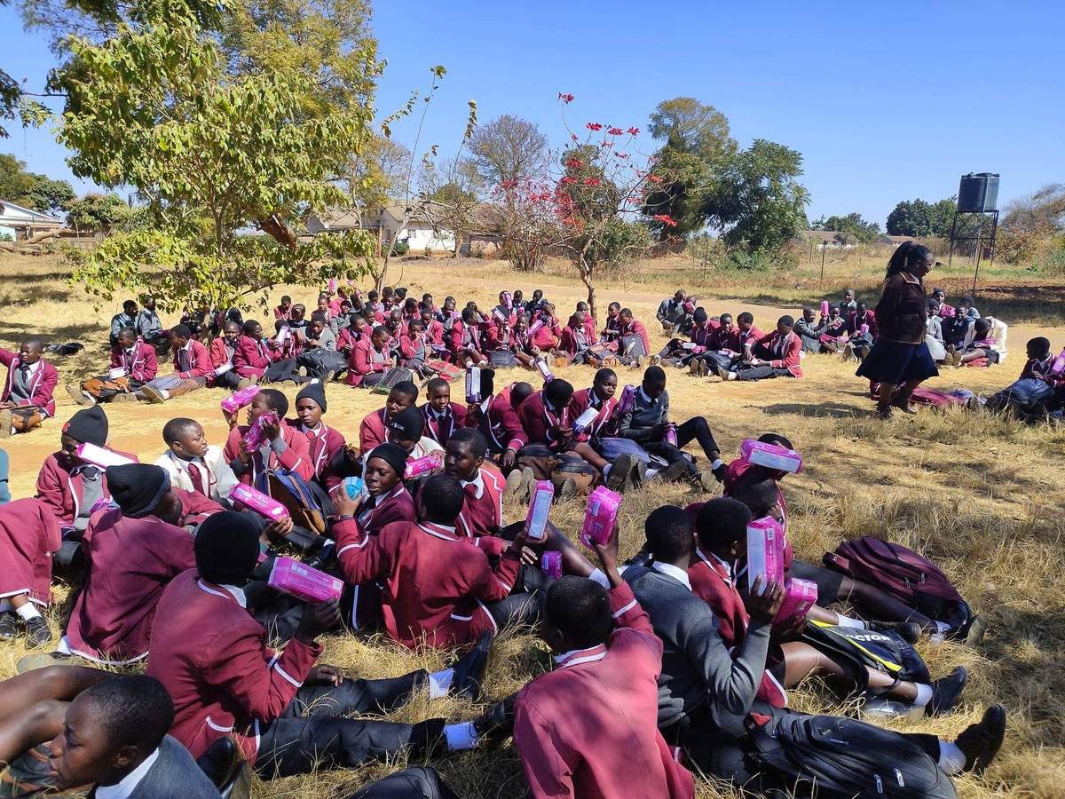 Children seated outdoors in maroon uniforms during the Kenya ministry visit