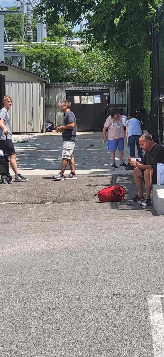 Volunteers walking along a city street delivering meals and hygiene supplies